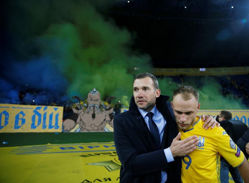 Ukraine's Mykola Matvyenko and coach Andriy Shevchenko celebrate at the end of the match. Reuters
