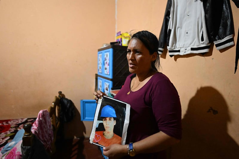 A woman shows a photo of her son who was detained during the state of emergency. AFP