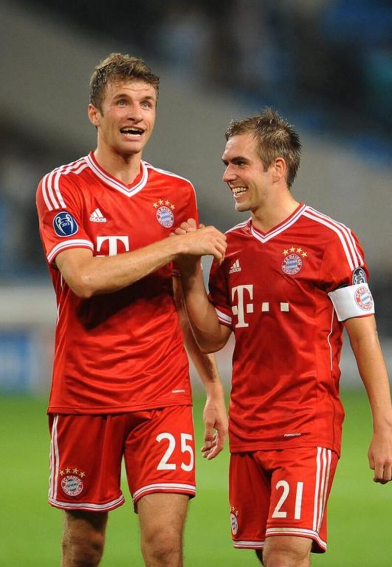 Thomas Mueller, left, and Philipp Lahm are examples of players brought up through Bayern Munich's system. Andreas Gebert / EPA