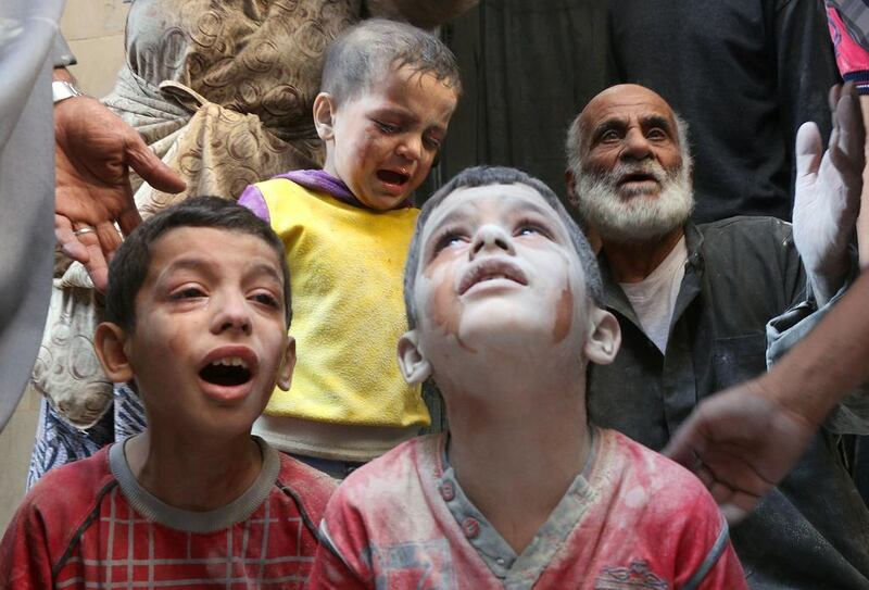 Syrian boys cry following Russian air strikes on the rebel-held Fardous neighbourhood of Aleppo on October 11, 2016. Thaer Mohammed/AFP

