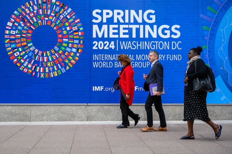 Pedestrians walk past International Monetary Fund headquarters in Washington ahead of the fund and World Bank 2024 Spring Meetings. AFP