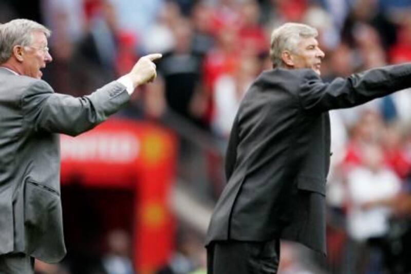 Manchester United manager Alex Ferguson (L) and Arsenal manager Arsene Wenger give instructions from the touchline during their English Premier League soccer match at Old Trafford, Manchester, northern England, September 17, 2006. NO ONLINE/INTERNET USE WITHOUT A LICENCE FROM THE FOOTBALL DATA CO LTD. FOR LICENCE ENQUIRIES PLEASE TELEPHONE +44 207 298 1656. REUTERS/Phil Noble (BRITAIN)
Picture Supplied by Action Images *** Local Caption *** 2006-09-17T173815Z_01_MCR20_RTRIDSP_3_SPORT-SOCCER.jpg