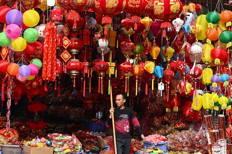 A vendor stands by his decorations shop in Hanoi. Vietnam's economy grew by more than 5 per cent in 2023. AFP
