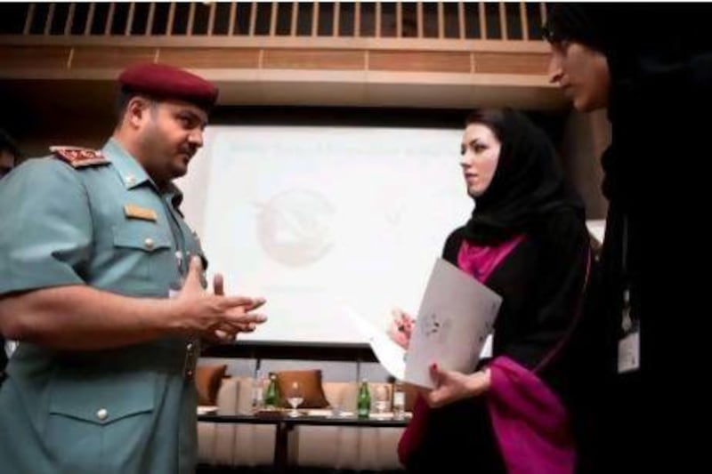 Lt Col Faisal Mohammed Al Shamari, director of the Ministry of Interior Child Protection Centre, talks with Samia Kazi, chief operating officer of Arabian Child, second right, at the forum in Dubai on Saturday.