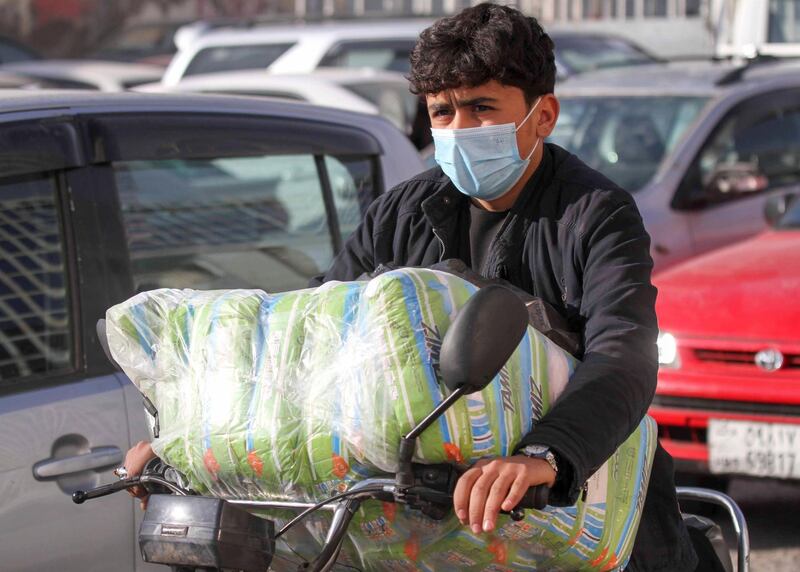 An Afghan man wears a face mask as he rides his motorbike in Herat province. Reuters