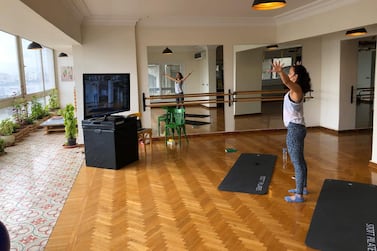 Fitness instructor Sarah Helmy leads a fitness class using the videoconference application Zoom from her studio in Cairo. Photo by Abu Bakr Shaaban