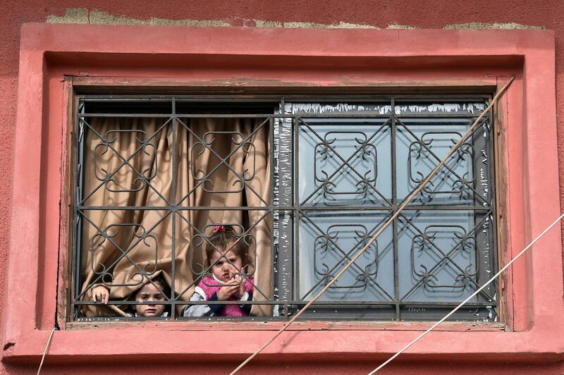 Girls look from a window of their school in Danniyeh, Beirut, Lebanon. EPA