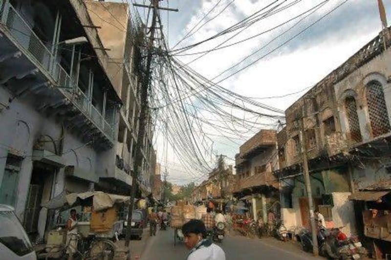 Overhead wire cables hang hang from an electricity pole installed by Torrent Power in Agra. Brijesh Singh / Reuters