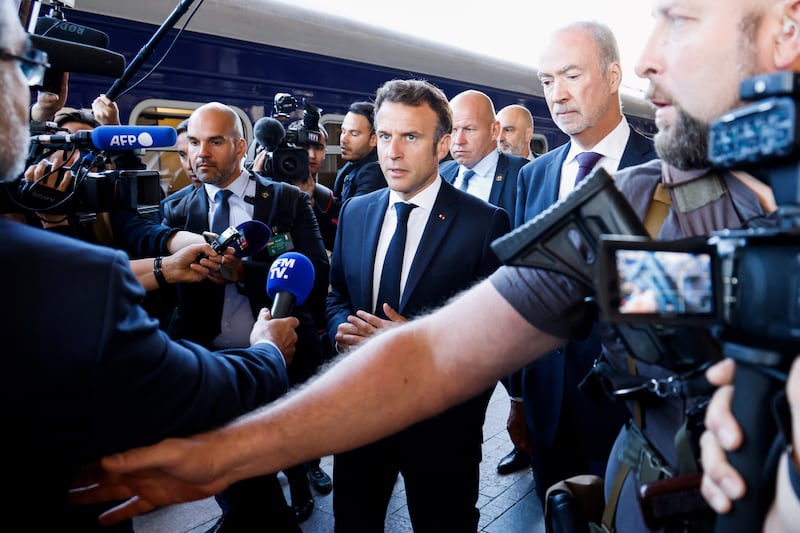 Mr Macron speaks to journalists at a Kyiv railway station. EPA 