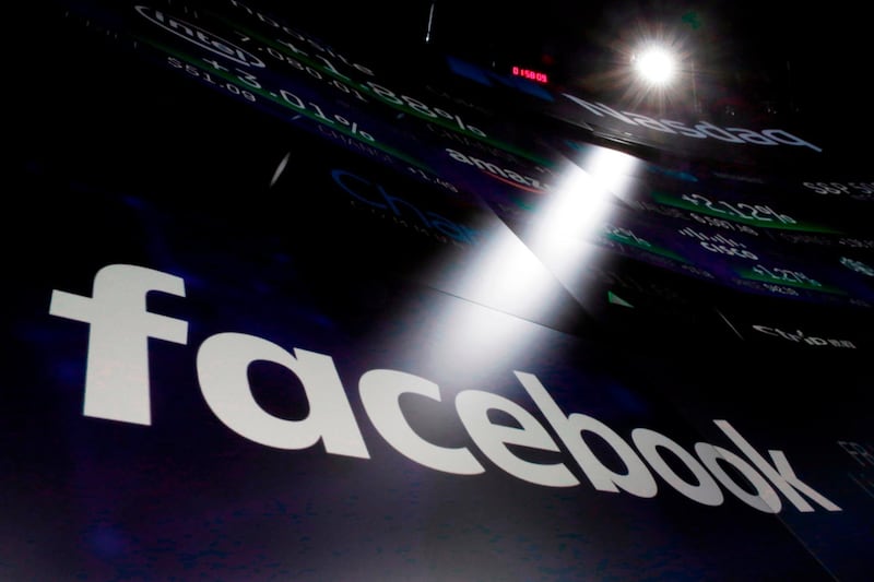 FILE- In this March 29, 2018, file photo, the logo for Facebook appears on screens at the Nasdaq MarketSite in New York's Times Square. Facebook reports earnings Wednesday, April 25. (AP Photo/Richard Drew, File)