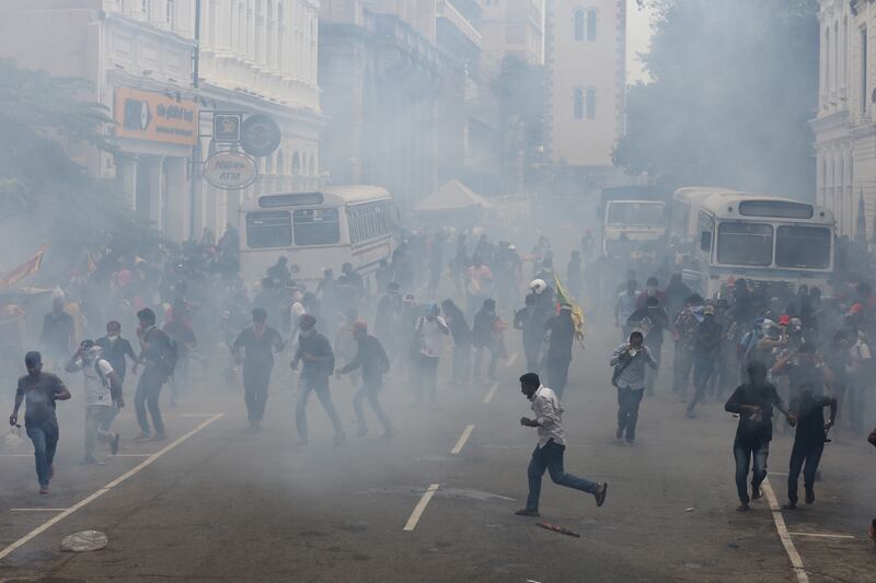 Security forces fire tear gas to disperse an anti government protest rally. EPA 