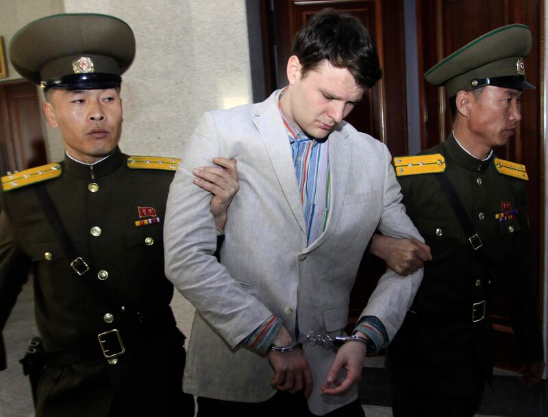FILE �������� In this March 16, 2016, file photo, American student Otto Warmbier, center, is escorted at the Supreme Court in Pyongyang, North Korea. Fred and Cindy Warmbier, the parents of a young Ohioan who was detained in North Korea for more than a year and died soon after being released, appeared on Fox News' "Fox & Friends" morning TV show Tuesday, Sept. 26, 2017, saying their son was "jerking violently," howling, and "staring blankly" when he returned home on a medical flight that arrived June 13 in Cincinnati. He died less than a week after returning at University of Cincinnati Medical Center. (AP Photo/Jon Chol Jin, File)