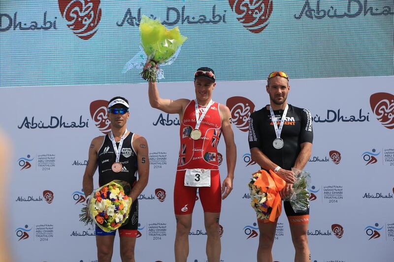 Tyler Butterfield, centre, surprised himself by winning the elite male long course division. Bas Diederen, right, and Sylvain Sudrie, left, and were second and third, respectively, in the Abu Dhabi International Triathlon on March 15, 2014. Ravindranath K / The National
