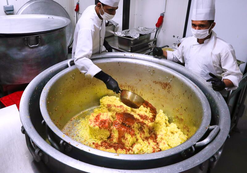 The biryani spices, rice and chicken are mixed to prepare biryani. 