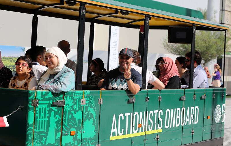 Cop28 visitors ride a train in the Green Zone at Expo City Dubai. Pawan Singh / The National