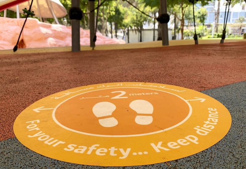 DUBAI, UNITED ARAB EMIRATES , October 10 – 2020 :- 2 meter distance sticker pasted on the floor at the kids play area at the Zabeel park in Dubai. Stickers about Covid safety measures pasted all over the park for the visitors. (Pawan Singh / The National) For News/Stock/Online.