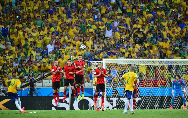 Brazil forward Neymar kicks the ball from a set piece during his side's 2014 World Cup Group A match on Tuesday against Mexico. Yuri Cortez / AFP