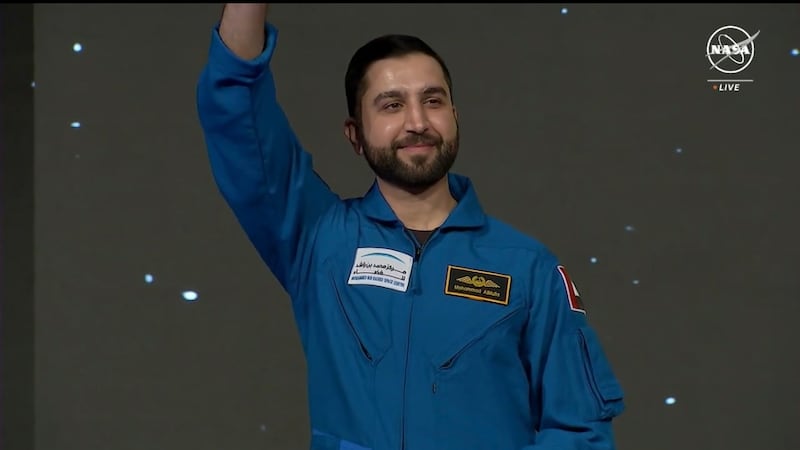 Emirati astronaut Mr Al Mulla waves to the crowd at the graduation ceremony. Photo: Nasa TV
