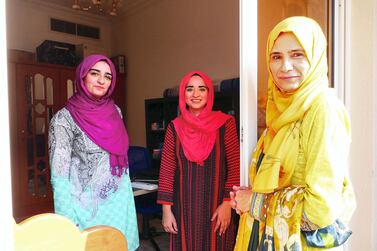 Najma Kolsawala, right, used to check on her daughters Neha Mohammed Tahir, centre, and Jawahir Mohammed Tahir from their home's shared balcony when the girls contracted Covid-19. Pawan Singh / The National