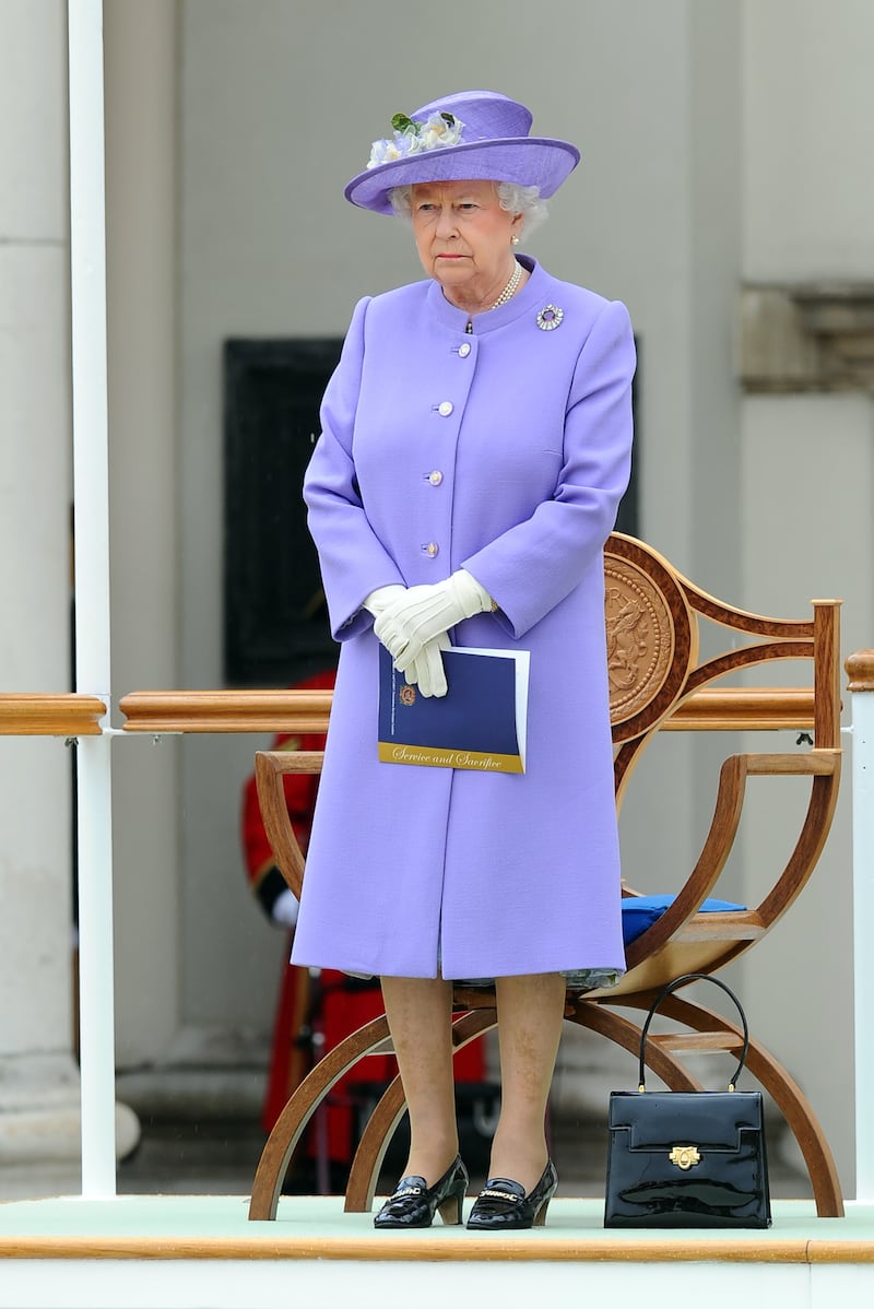 Queen Elizabeth II, in lilac, attends the Solemn Drumhead service at Royal Hospital Chelsea on June 28, 2014, in London. Getty Images