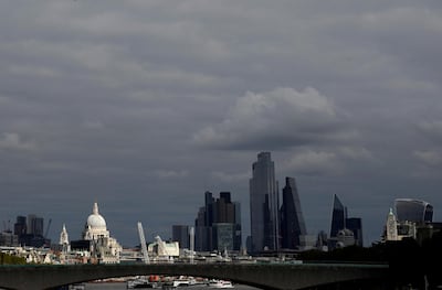 FILE PHOTO: St Paul's Cathedral is seen together with skyscrapers in the City of London financial district, Britain, October 16, 2020. REUTERS/Toby Melville/File Photo