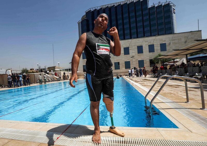 An Iraqi civilian who lost a limb during the government offensive against Isis in the northern city of Mosul stands by a swimming pool in Arbil, the capital of the Kurdish autonomous region in northern Iraq. AFP