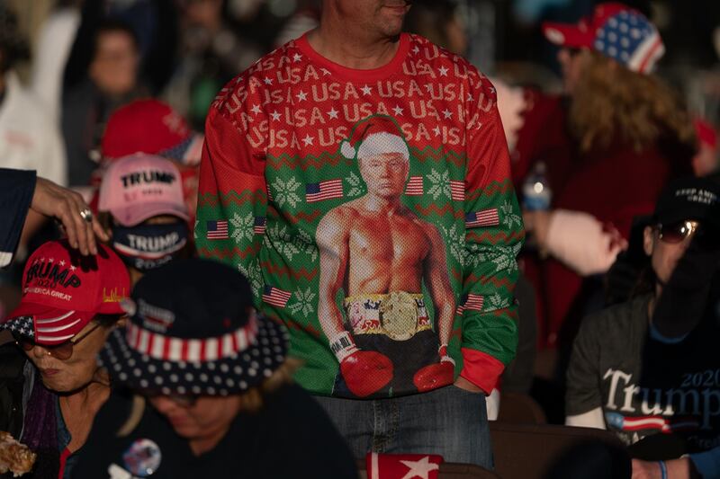 An attendee wears a holiday sweater featuring U.S. President Donald Trump during a rally with in Valdosta, Georgia, U.S. Bloomberg
