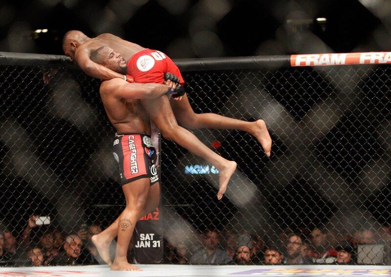 Challenger Daniel Cormier lifts Jon Jones for a slam during their title fight at UFC 182 on Saturday. Steve Marcus / Getty Images / AFP