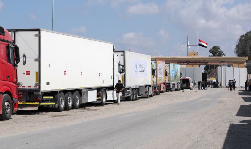 Trucks of a humanitarian aid convoy have been waiting outside the border gate between Egypt and Gaza for days. EPA