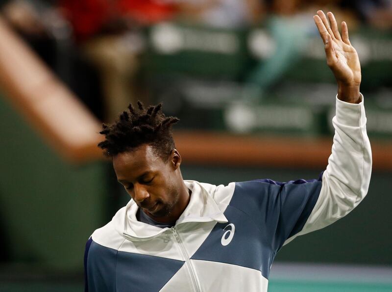 epa07438040 Gael Monfils of France waves to the crowd after he announces he has to withdraw due to an injury before his match against Dominic Thiem of Austria during the BNP Paribas Open tennis tournament at the Indian Wells Tennis Garden in Indian Wells, California, USA, 14 March 2019.  EPA/LARRY W. SMITH