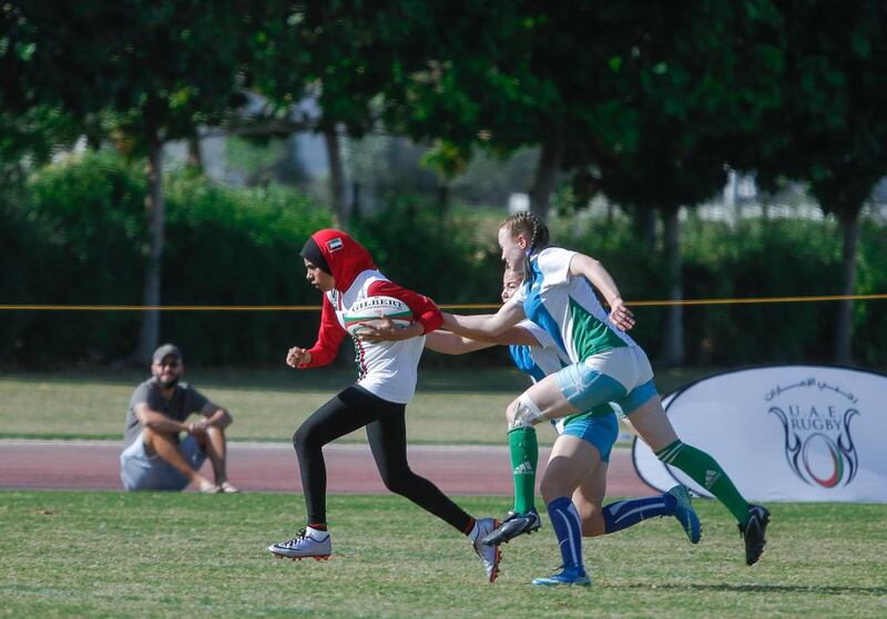 The UAE's Hamda Waleed, centre, makes a run through the Uzbekistan defence during the Under 18 Girls International Tournament at the Dubai Rugby Sevens in December 2016.