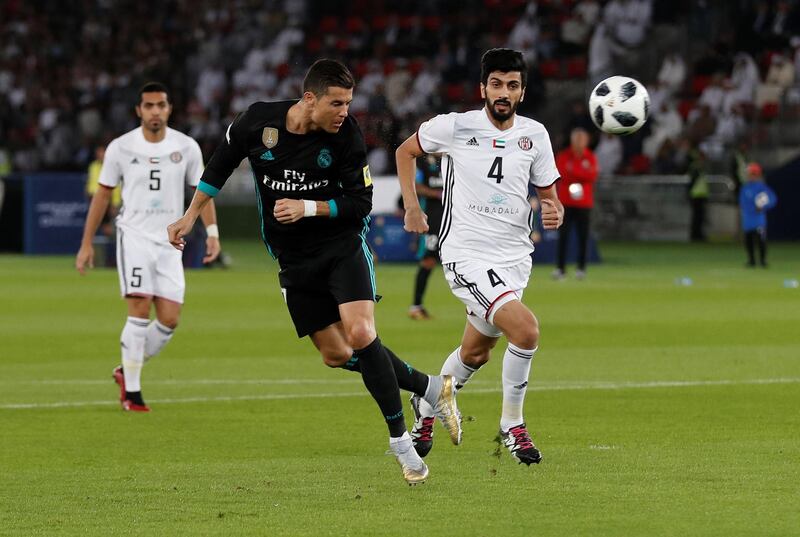 Real Madrid’s Cristiano Ronaldo in action with Al Jazira’s Mohammed Ali Ayed. Matthew Childs / Reuters