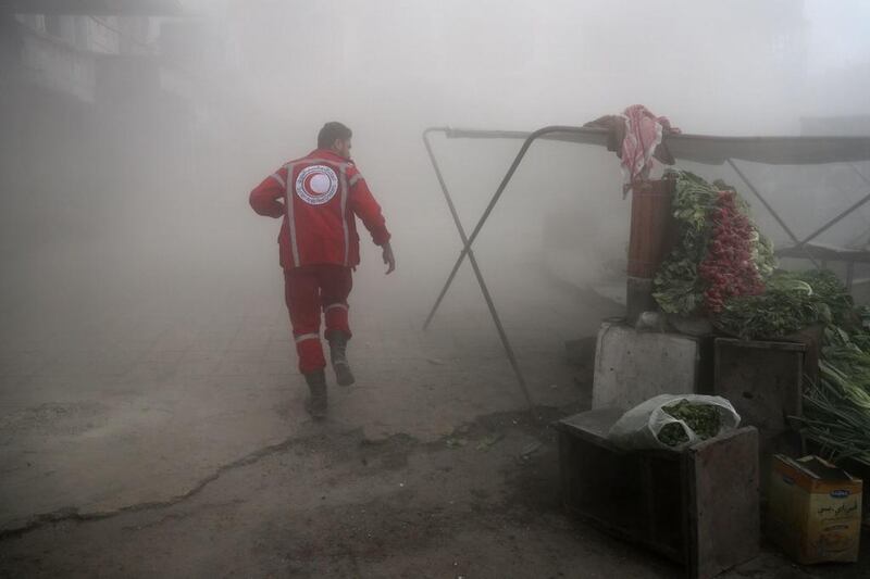 The Syrian Arab Red Crescent searches for victims following a reported government airstrike on the rebel-held town of Douma, Syria, on the eastern outskirts of the capital Damascus, on November 10, 2016. At least 11 people were killed in the air strikes, according to the Syrian Observatory for Human Rights. Abd Doumany / Agence France-Presse