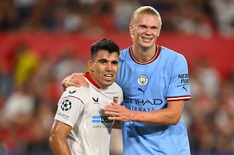 Sevilla's Marcos Acuna with City's Erling Haaland. Getty