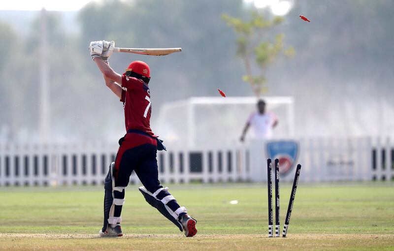 ABU DHABI , UNITED ARAB EMIRATES , October 22  – 2019 :- Harrison Carlyon of Jersey bowled out by Waheed Ahmed during the World Cup T20 Qualifiers between UAE vs Jersey held at Tolerance Oval cricket ground in Abu Dhabi.  ( Pawan Singh / The National )  For Sports. Story by Paul