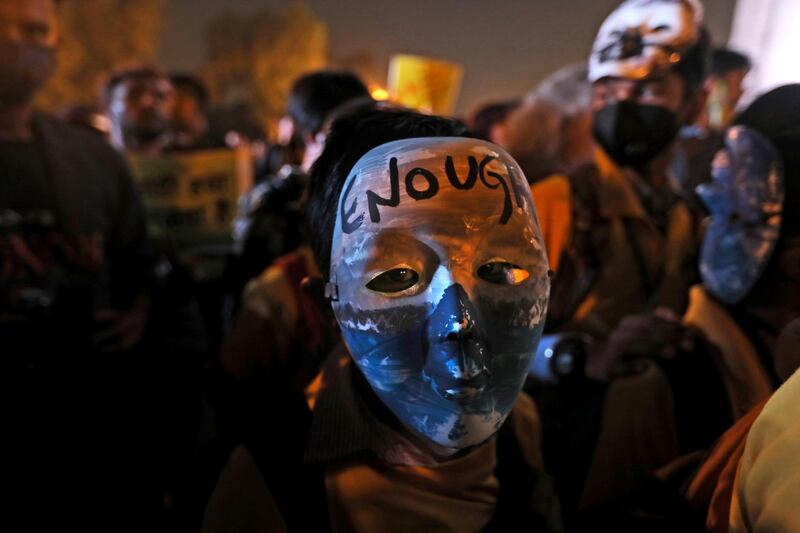 A child sports a mask with the words 'Enough' during a protest against the alarming levels of pollution in the city, near the India Gate monument in New Delhi, India. AP Photo