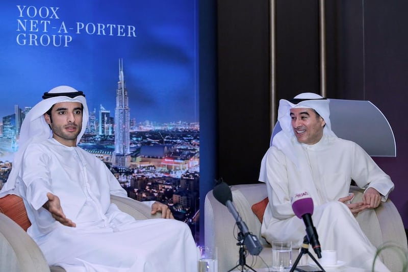 Mohamed Alabbar, right, and son Rashid share details of the Yoox Net-a-Porter deal. Victor Besa for The National