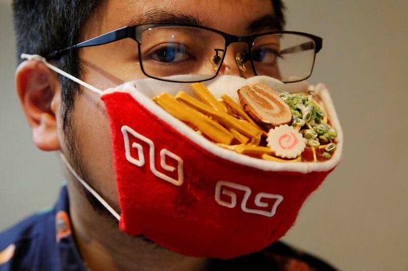 Japanese designer Takahiro Shibata wears a protective mask that looks like a steaming bowl of ramen noodle soup in Yokohama, Japan. Reuters