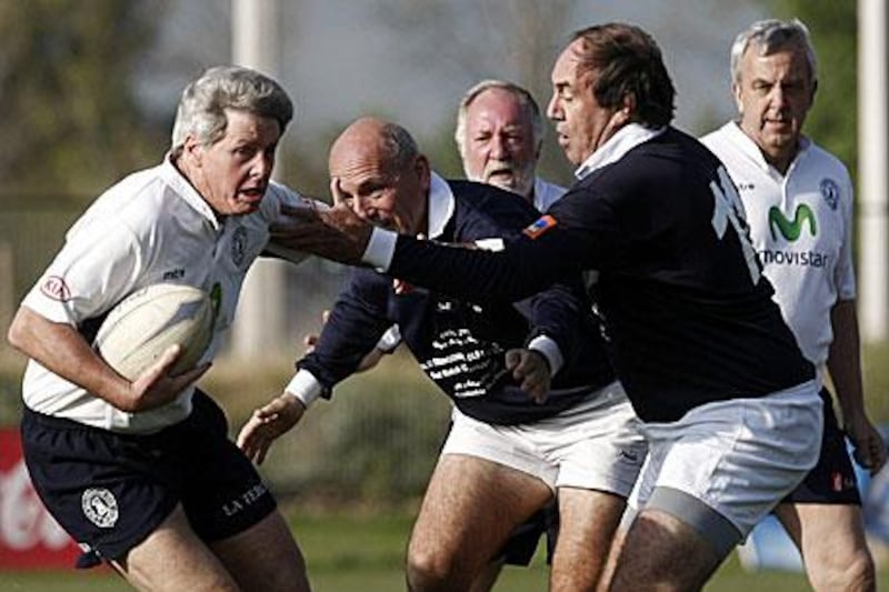 Fernando Parrado, right one of the survivors from the 'Tragedy of the Andes' attempts to tackle a Chilean player in their rugby match which was supposed to have taken place 40 years ago.