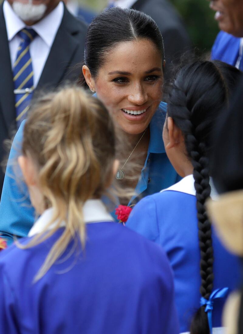 Meghan, Duchess of Sussex talks with students at Tupou College. Getty Images