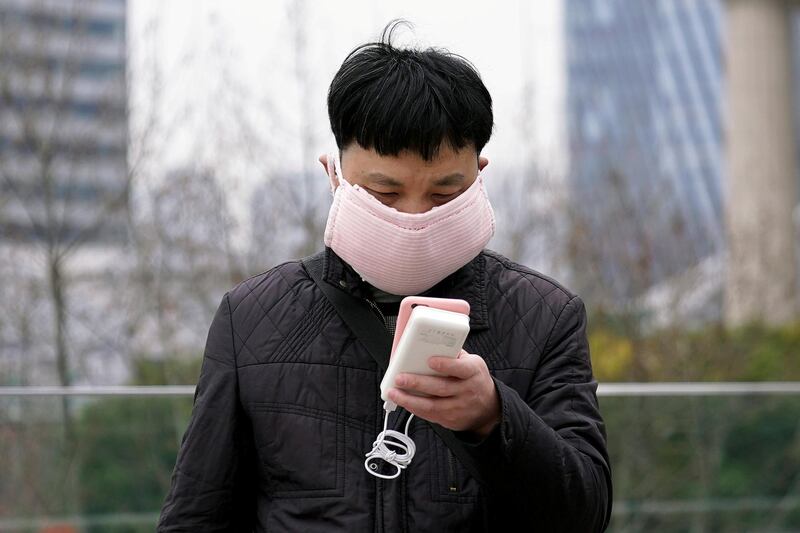A man wearing a handmade face mask is seen in Shanghai, China, as the country is hit by a novel coronavirus outbreak, at the Pudong financial district in Shanghai, China February 28, 2020. REUTERS/Aly Song