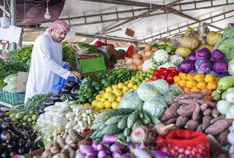 Abu Dhabi, U.A.E., January 5, 2018.  The Abu Dhabi Fruits and Vegetable Market at Port Zayed is the main fruit and vegetable market at Abu Dhabi, UAE.  A local resident picks out some fresh eggplant at the vegetable market.
Victor Besa / The National
Stand Alone for Rob Gurdebeke
