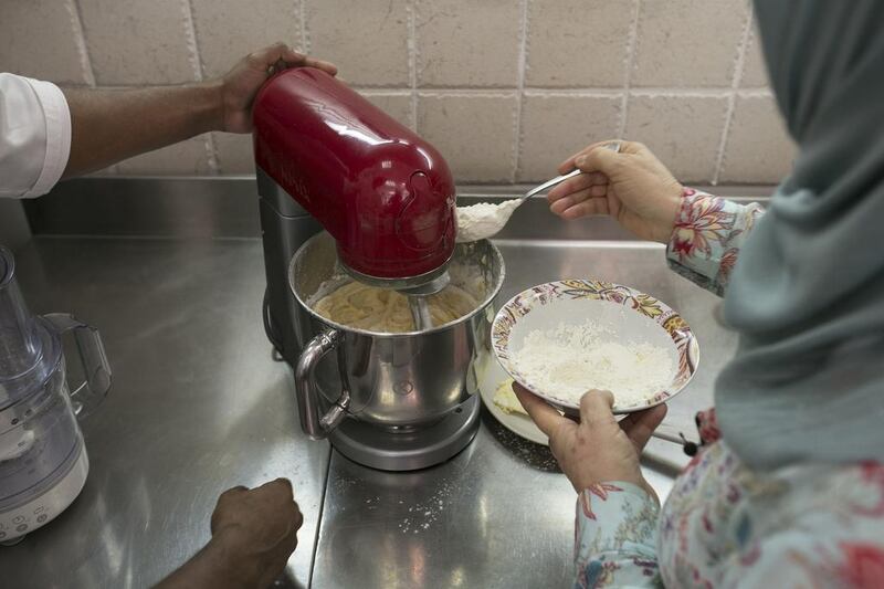 The sifted flour gets added to the mixture. Next, the milk is added a little bit at a time until the mixture becomes smooth.