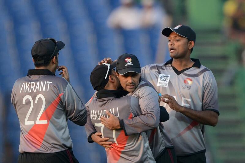 Khurram Khan, second from right, has served UAE cricket well for many years and will cap a long career with the World Cup. Munir uz Zaman / AFP