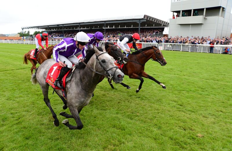 Capri ridden by Seamie Heffernan, in front, before winning the Dubai Duty Free Irish Derby at Curragh Racecourse. Press Association