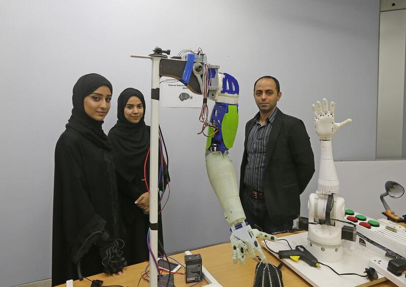 From left: Mouza Alahbabi, Nouf Alsaedi, and Fady Al Najjar, assistant professor at the College of Information Technology. The basic arm costs about Dh10,000 and has a built-in camera. Jeffrey E Biteng / The National
