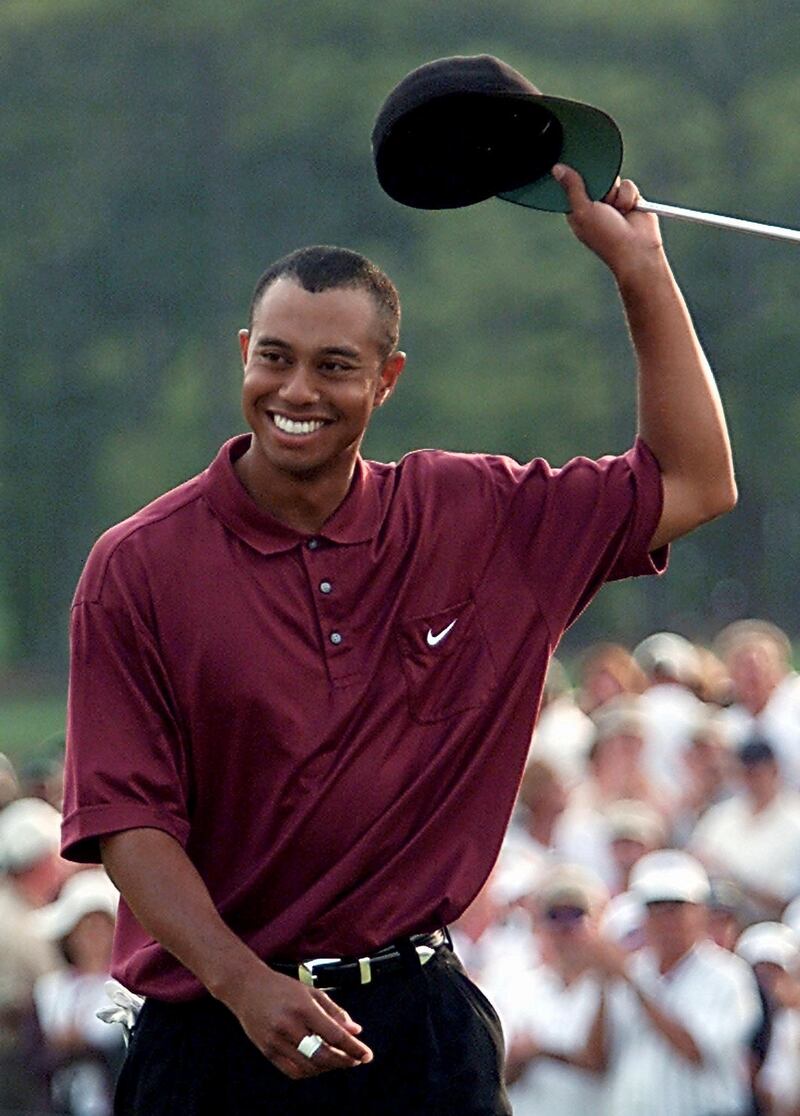Tiger Woods waves to the gallery after winning the 2001 Master at the Augusta National Golf Club 08 April 2001 in Augusta, Georgia. Woods held his nerve in one of the most thrilling final days in Masters history to become the first player ever to hold all four Major titles at the same time. AFP PHOTO/Robert SULLIVAN (Photo by ROBERT SULLIVAN / AFP)