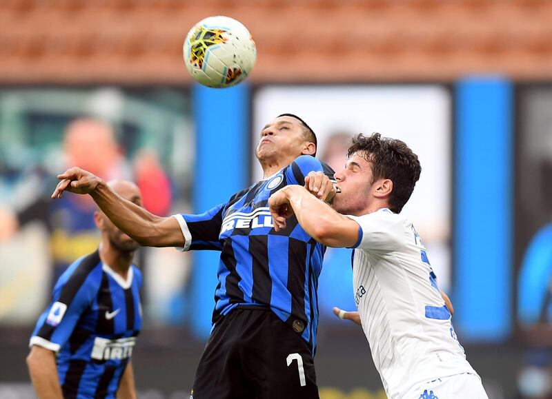 Inter Milan's Alexis Sanchez and Brescia's Stefano Sabelli challenge for the ball. Reuters