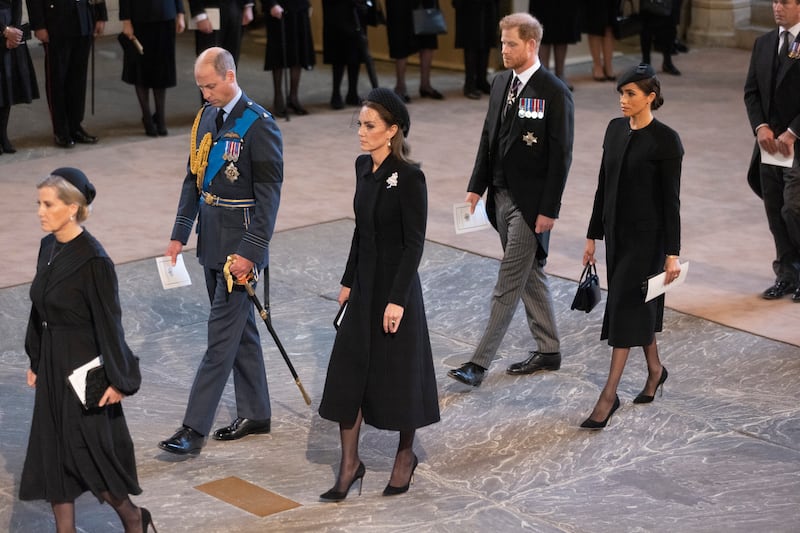 Prince William, his wife Catherine, Princess of Wales, Prince Harry, and his wife Meghan, Duchess of Sussex, at Westminster Hall as the queen's coffin is carried in. Getty Images