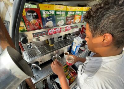 Youssef, 16, makes coffee at his father's portable cafe. The makeshift coffee shop is built into a converted microbus. Kamal Tabikha / The National